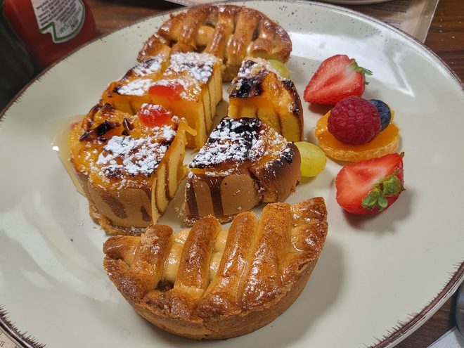 A sliced pastry dessert with berries.
