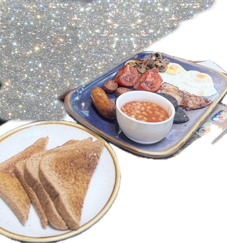 Full English breakfast with bacon, sausage, fried eggs, mushrooms, tomato, black pudding and beans.